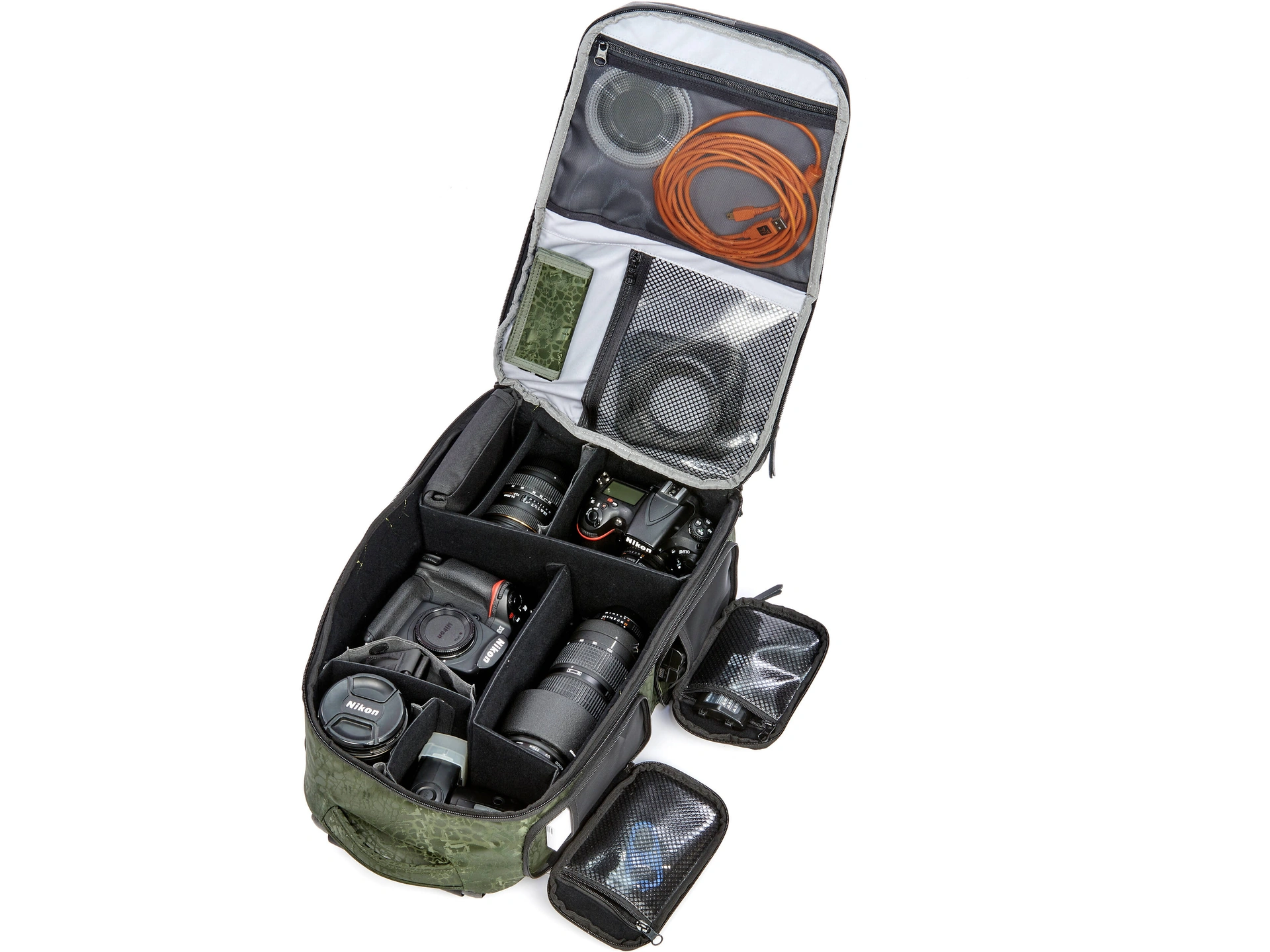 A backpack containing binoculars, a camera, a field guide, a water bottle, and other essential birdwatching gear.